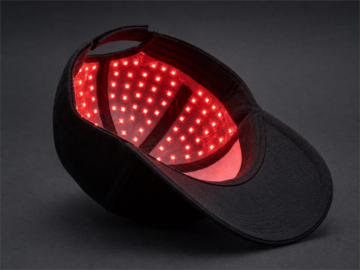 Close view of the illuminated red light array inside the TrichoGlow cap