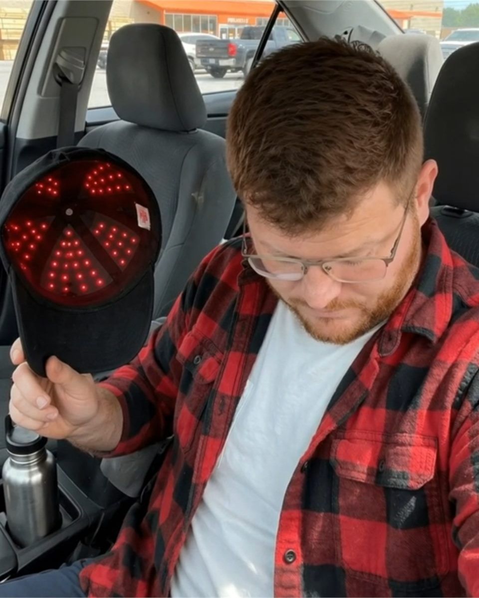 Customer showing the illuminated TrichoGlow cap